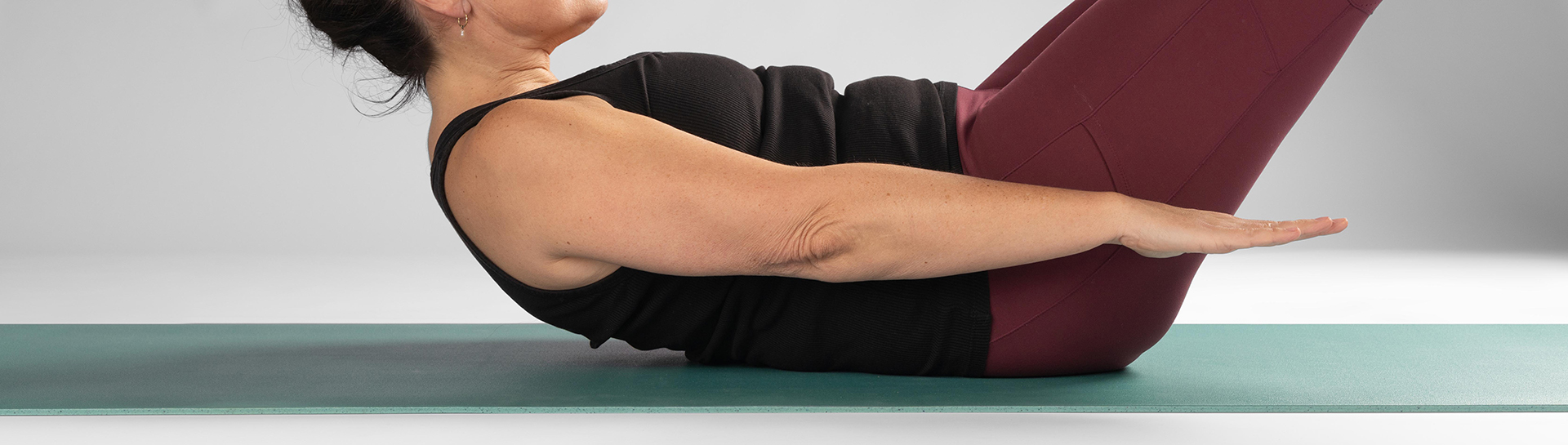 Women enjoying the comfort and stability of a KURMA CORE 6.5 mm thick mat whilst performing the Pilates 100 series exercise